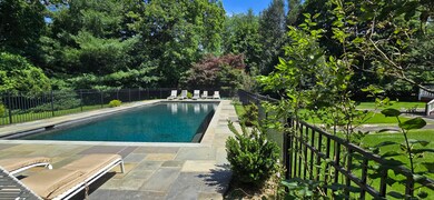 Well maintained heated pool ...fenced-in with a pool house or guest house.