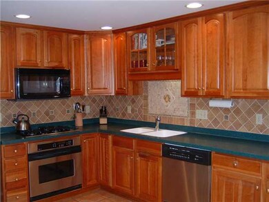Kitchen. Cherry cabinets, solid surface counter to
