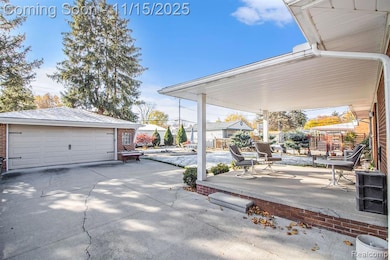 View of patio / terrace with an outdoor structure and a detached garage