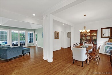 Dining room with crown molding, recessed lighting,