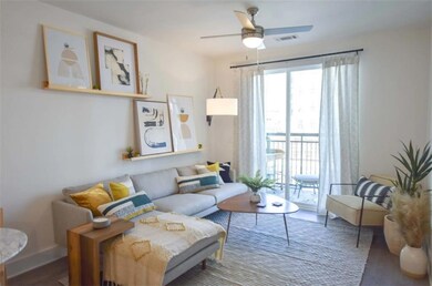Living room featuring ceiling fan and hardwood / w