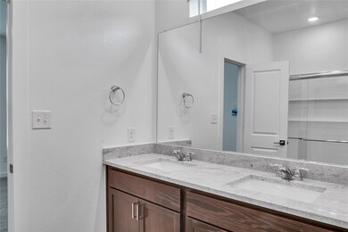 Bathroom featuring a sink and double vanity