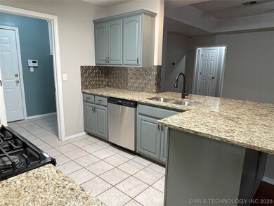 new d/w, sink, faucet, tile floors- open concept.