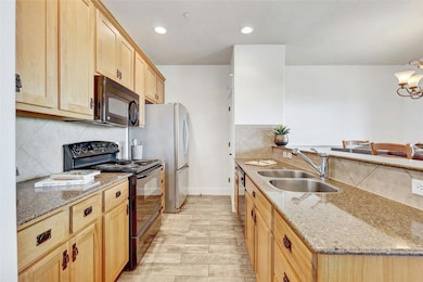Kitchen with light stone counters, a peninsula, l