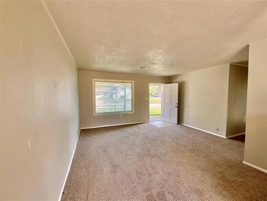 Carpeted empty room with a textured ceiling