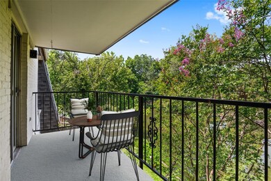 Balcony view of tree tips and lake