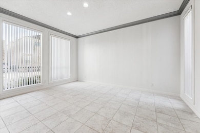 Another view of the spacious well-lit dining room with custom verical blinds. What a beautiful space to entertain family and friends.
