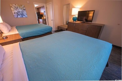 Bedroom featuring freestanding refrigerator