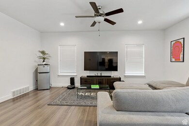 Living room featuring wood finished floors, recessed lighting, and a ceiling fan
