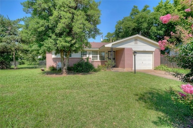 Ranch-style home with brick siding, a garage, and concrete driveway