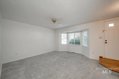 Entryway with a ceiling fan, carpet flooring, and healthy amount of natural light