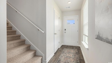 Entrance foyer featuring stairway and dark wood finished floors