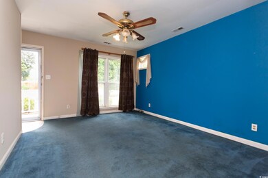 Empty room featuring ceiling fan and carpet floori