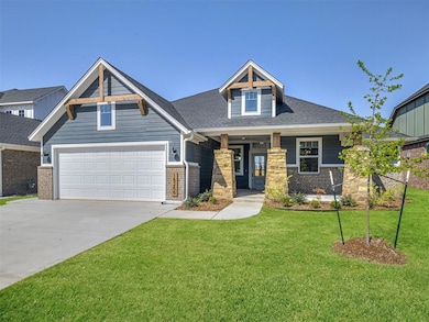 Craftsman house with driveway, a front yard, a shingled roof, stone siding, and covered porch