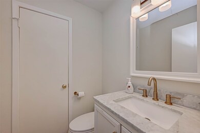 This half bathroom is conveniently located on the