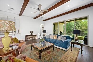 Living room featuring beam ceiling, hardwood / wo