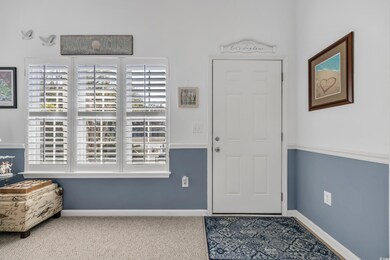 Carpeted entrance foyer featuring baseboards