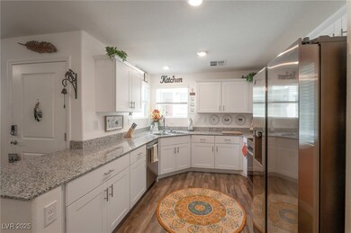 Kitchen featuring stainless steel dishwasher, whit