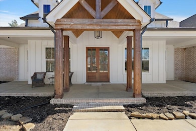 Property entrance with a shingled roof, board and 