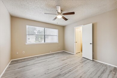 Unfurnished bedroom with wood finished floors, a 