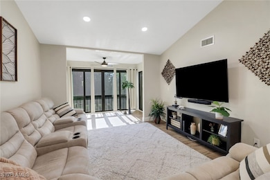 Living room with ceiling fan, lofted ceiling, and