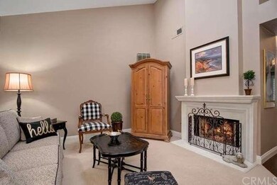 Living room with vaulted ceilings and cozy firepla
