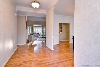 The inviting foyer, with hardwood floors, welcomes