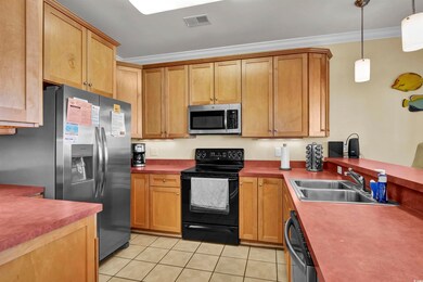 Kitchen with light tile patterned flooring, applia