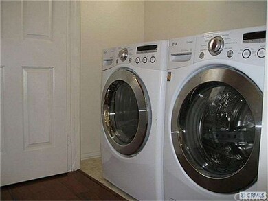 Brand new washer and dryer in laundry area.