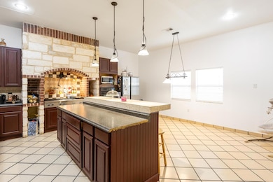 Kitchen featuring backsplash, stainless steel app