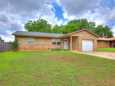 Ranch-style home with brick siding, an attached garage, and concrete driveway