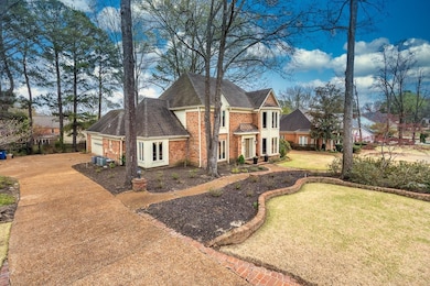 View of front of home with a front lawn, concrete 
