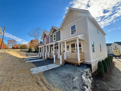 View of front facade with a porch and board and batten siding