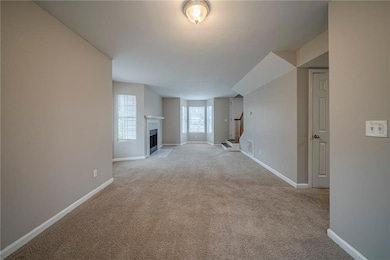 Unfurnished living room with light colored carpet