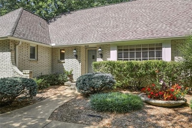 White brick and gorgeous landscaping make for a gr