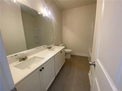 Bathroom featuring double vanity and tile patterned floors