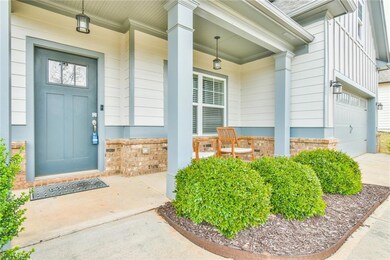 View of exterior entry with a porch, a garage, and