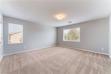 Unfurnished room with visible vents, baseboards, a