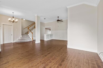 Unfurnished living room featuring ceiling fan with