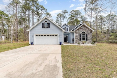 Traditional home featuring stone siding, a front y