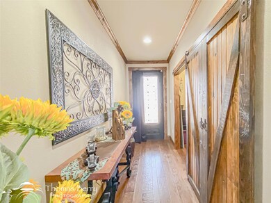 Entryway featuring crown molding and hardwood / wo