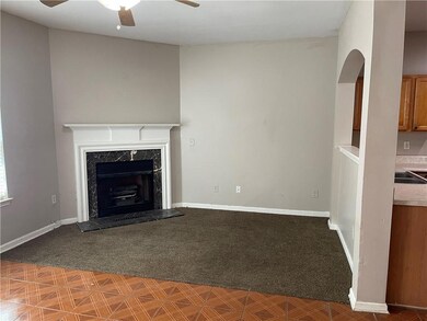 Unfurnished living room with carpet flooring, a ceiling fan, and a high end fireplace