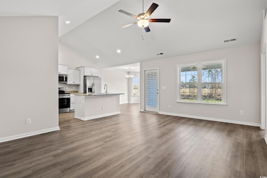 Unfurnished living room featuring a chandelier, ce