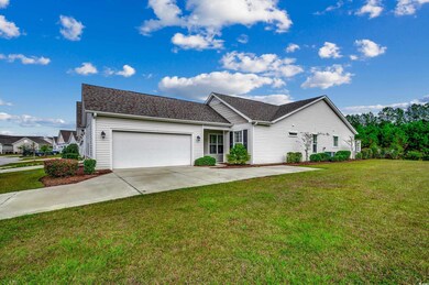 Ranch-style house with a front yard and a garage
