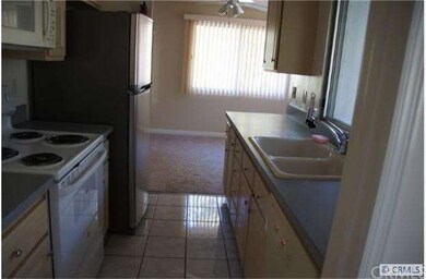 Kitchen has tile floors and matching appliances