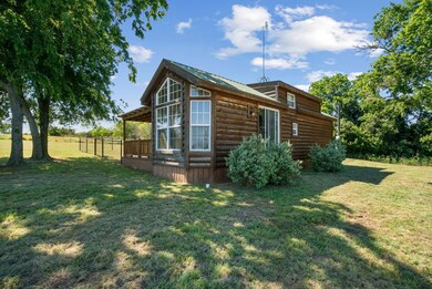 View of side of home featuring a yard