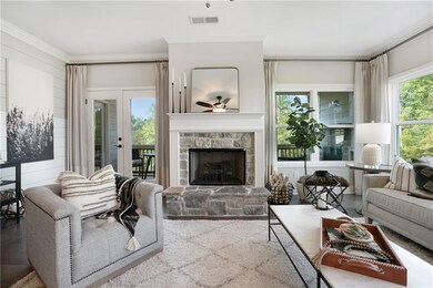 Living room with ceiling fan, plenty of natural light, a fireplace, and crown molding