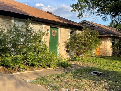 Doorway to property with brick siding and roof wi