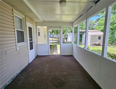Enclosed patio or sunroom area with a view of the