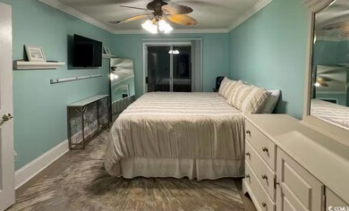 Bedroom with ornamental molding and a ceiling fan